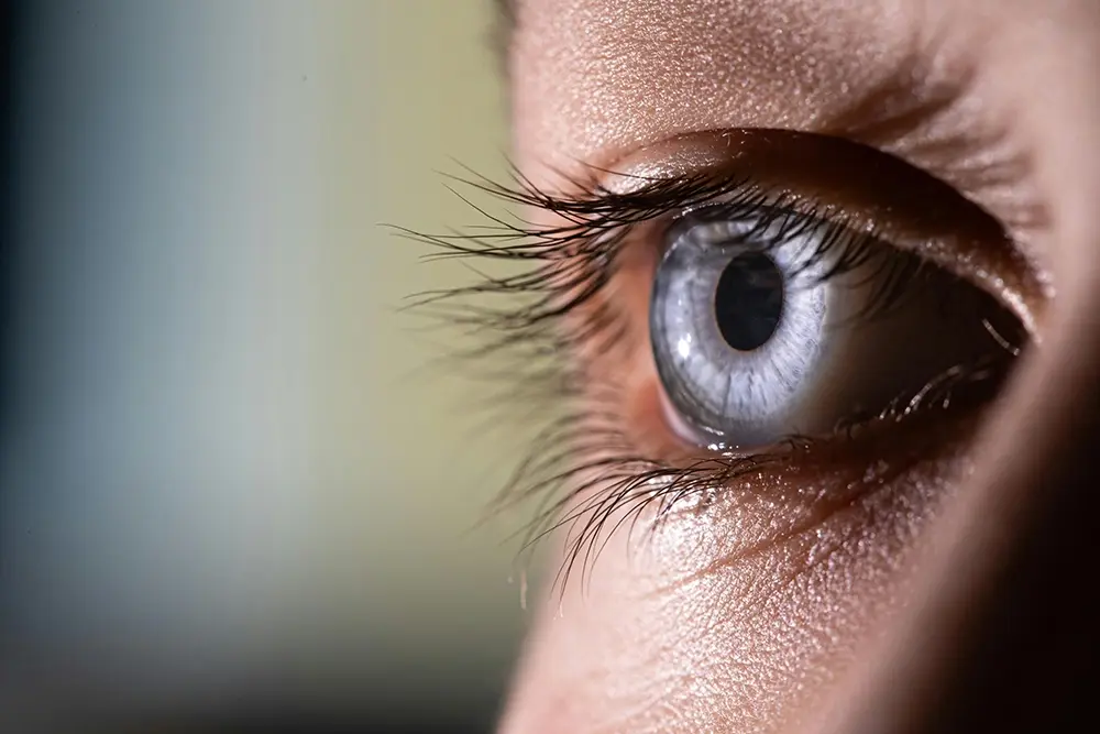 Person experiencing digital eye strain and dry eyes from prolonged screen use